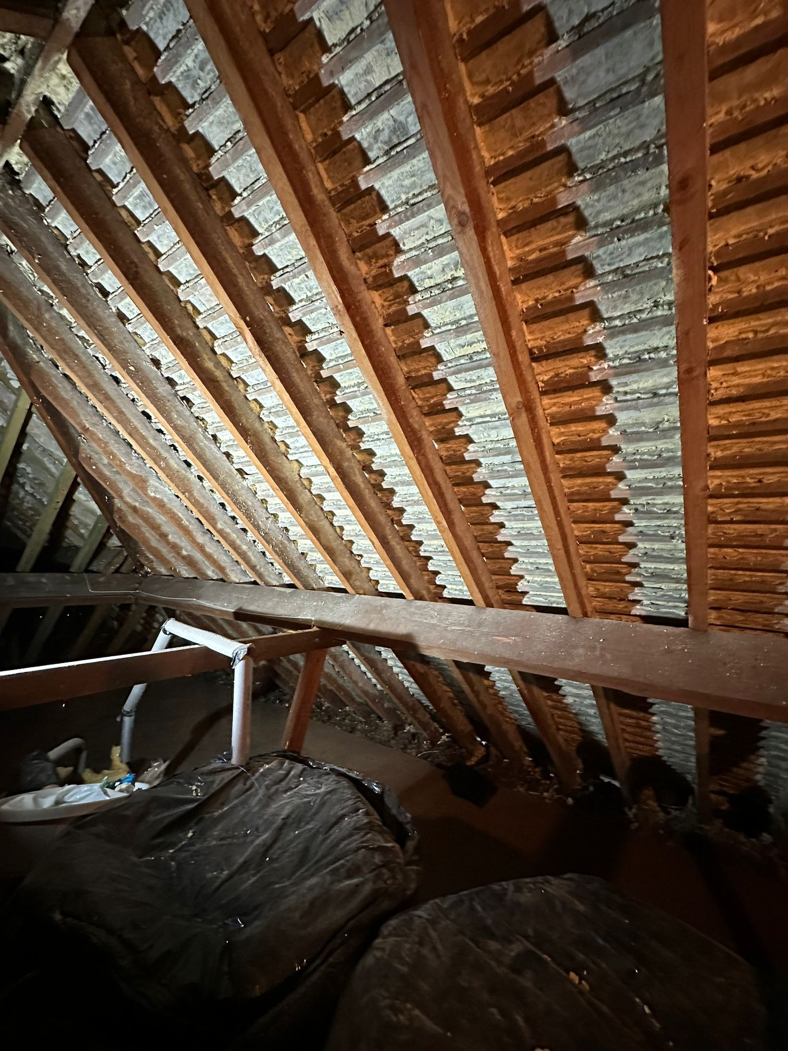Rafters and tile battens under a pitched roof after spray foam removal