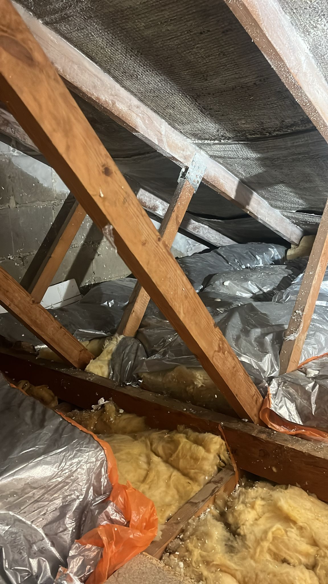 Multi-foil insulation and mineral wool in a loft, under its rafters