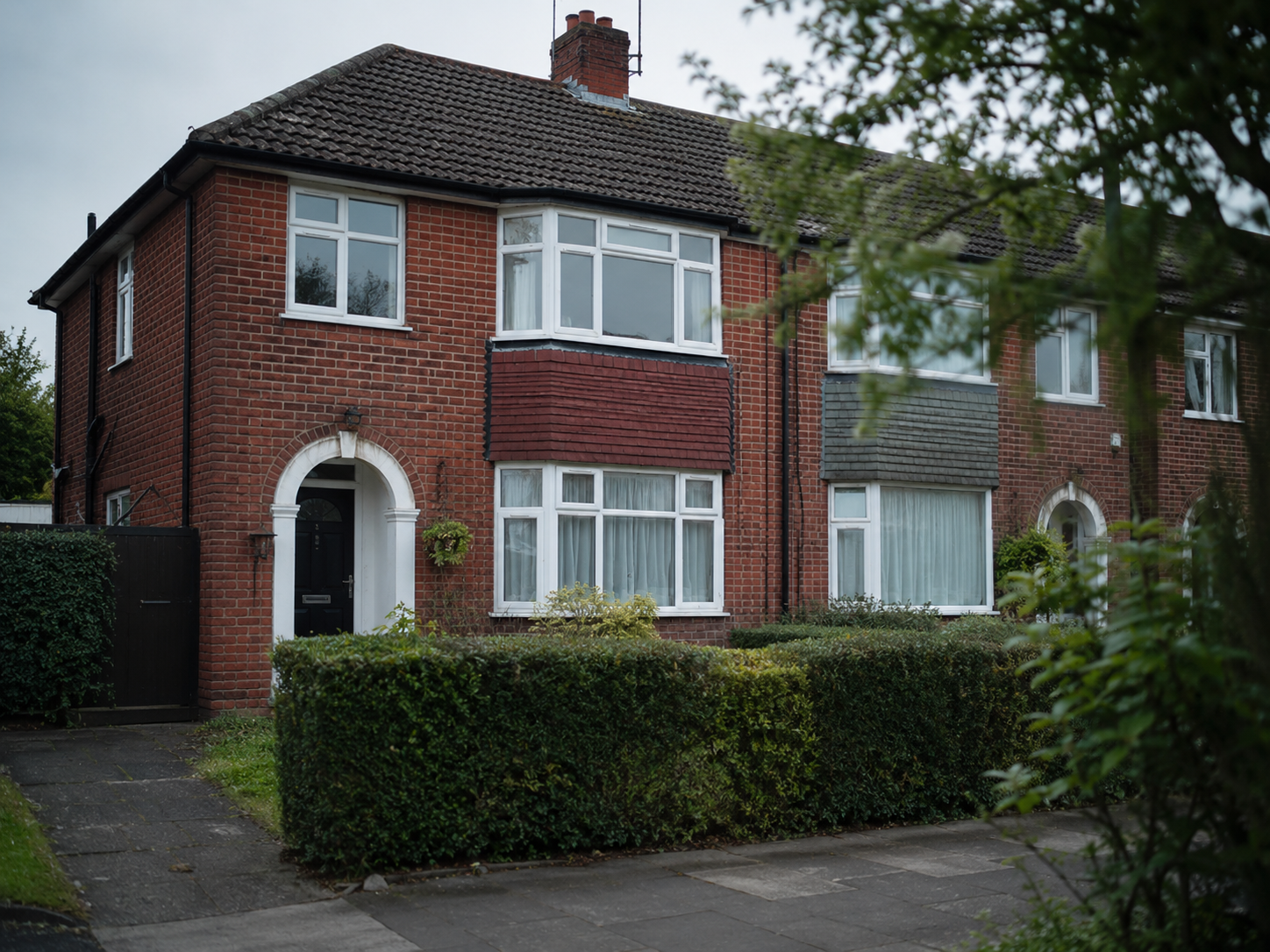 Photograph of a typical UK 1930s suburban semi-detached house exterior